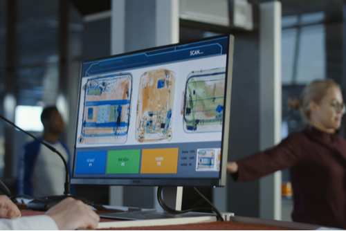 Luggage being scanned at airport security. 