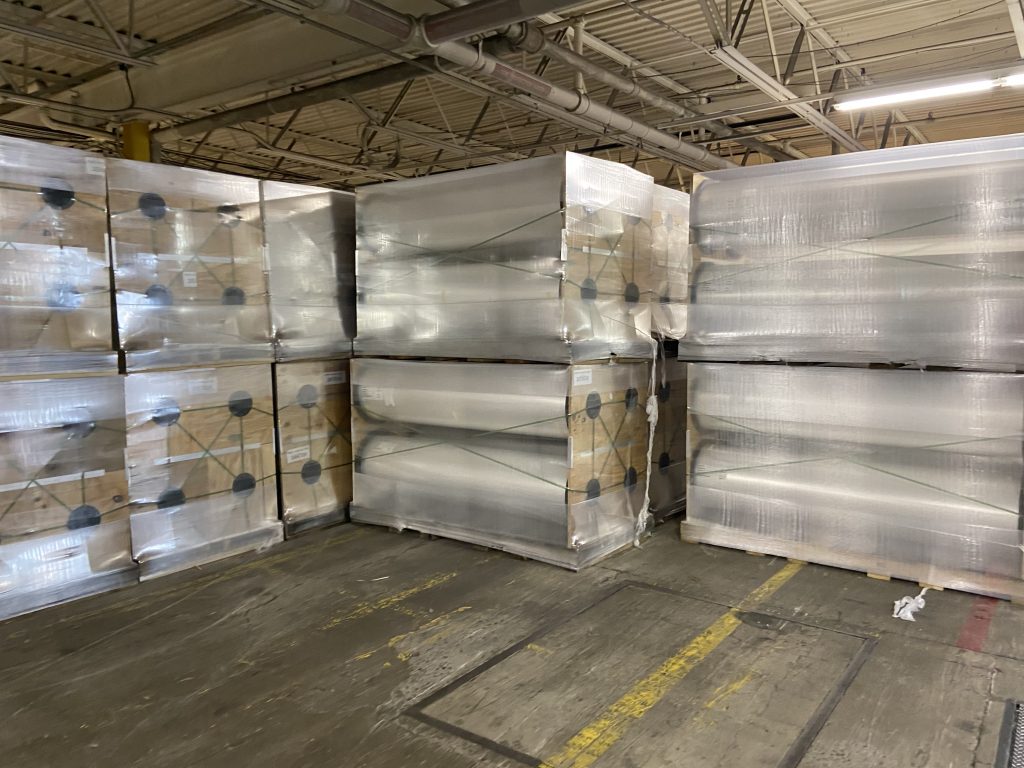 Warehouse holding several large rolls of polystyrene.