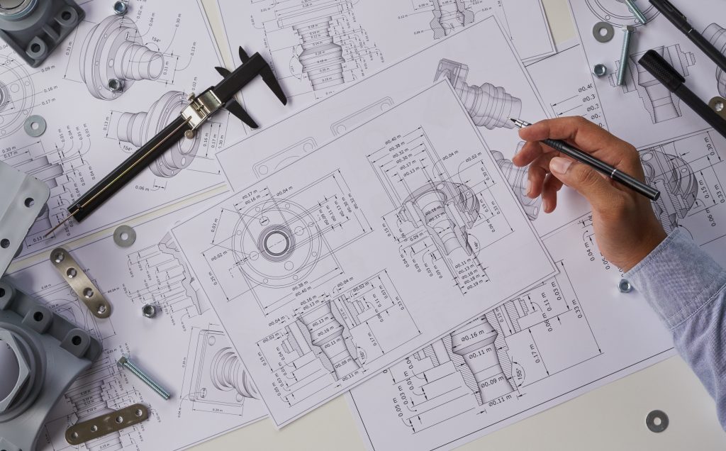 Engineer examining technical drawings.
