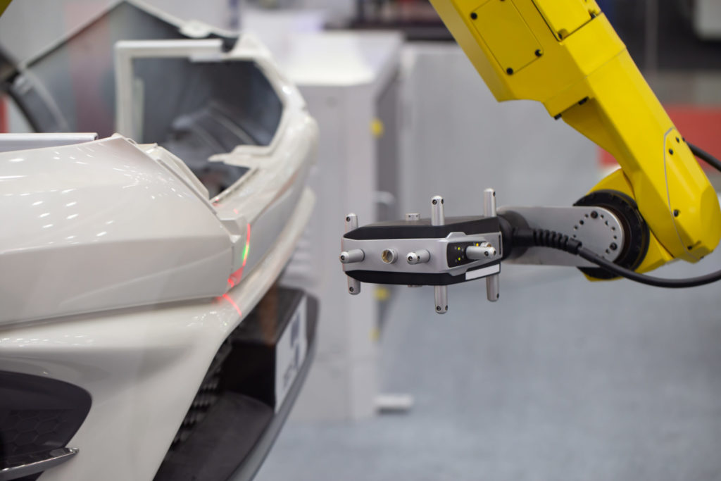Automated robotic CMM Coordinate Measuring Machine scanning car bumper automotive industry.