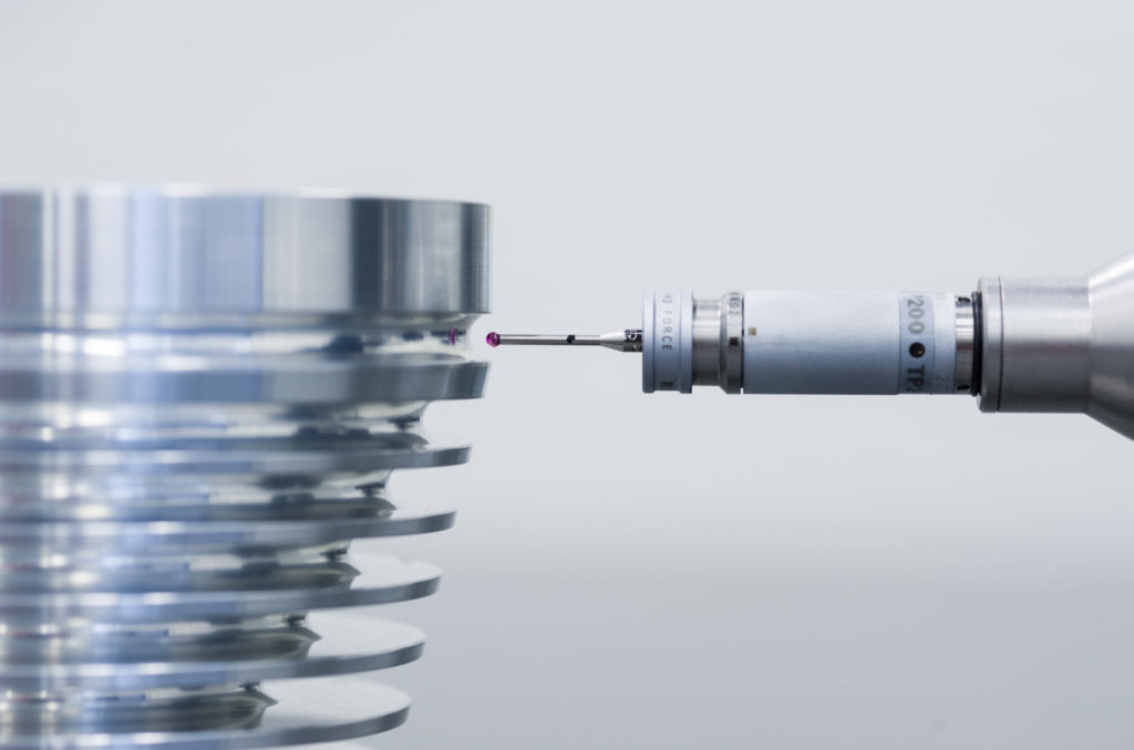 Automated dimension inspection of metal parts by CMM after machining process.